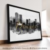 Framed artwork featuring a black and white cityscape of Denver with gold lettering.