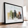 Framed artwork depicting a stylized cityscape of Denver with various buildings and colors.