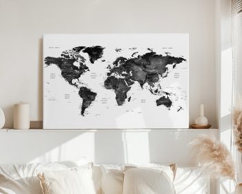 Black and white world map with country names and outlines displayed on a wall.