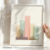 Art print of the Edmonton city skyline featuring various building shapes and colors in a framed display.
