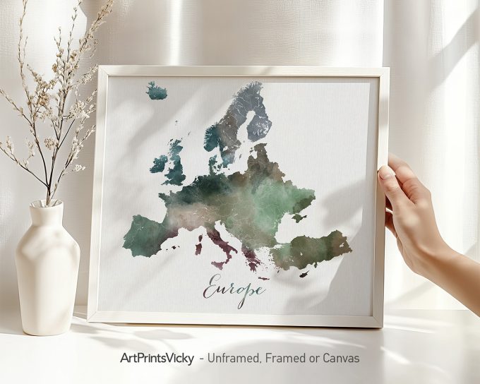 Watercolor map of Europe displayed in a frame with a hand holding it.