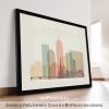Framed artwork depicting a stylized cityscape of Indianapolis with various buildings and skyline elements.