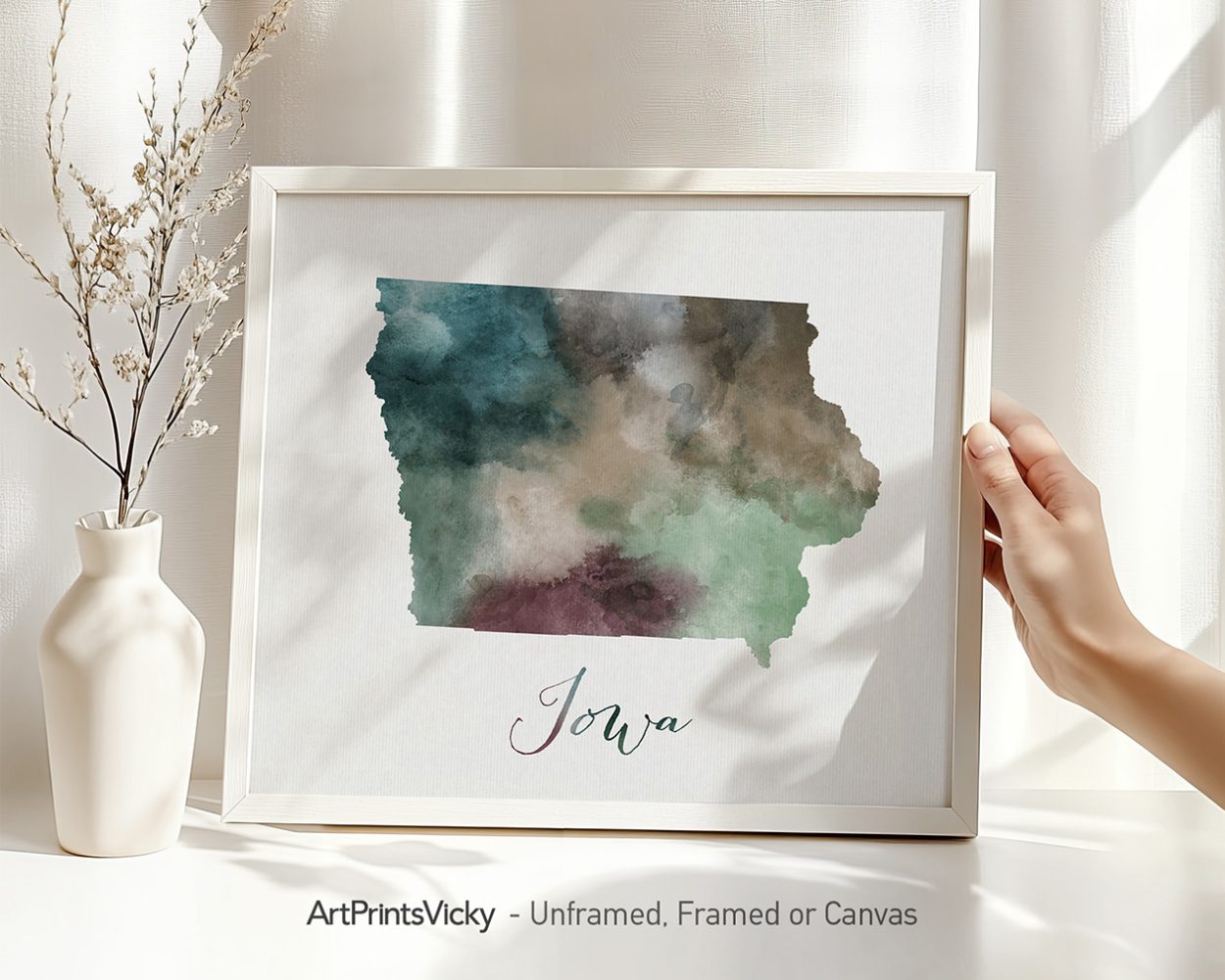 Watercolor illustration of the state of Iowa in shades of green and blue with the word 'Iowa' at the bottom.