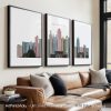 Three framed art prints depicting the skyline of Kansas City in various colors.