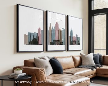 Three framed art prints depicting the skyline of Kansas City in various colors.