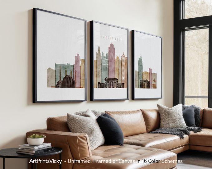 Three framed art prints of Kansas City skyline in various colors displayed on a wall.
