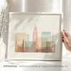 Framed artwork depicting a stylized cityscape of Lincoln with various buildings and structures.
