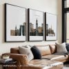 Three framed art prints depicting a cityscape of Lincoln with buildings and structures.