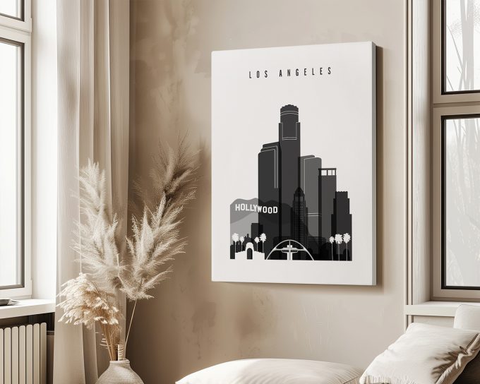 Black and white illustration of Los Angeles skyline with Hollywood sign and palm trees.