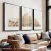 Three framed art prints depicting a stylized Los Angeles cityscape with Hollywood sign and skyline.