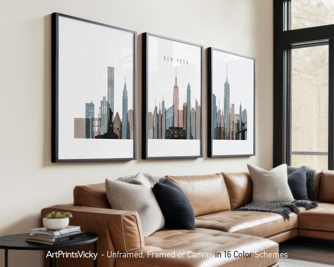 Three framed art prints depicting a stylized skyline of New York City with notable buildings.