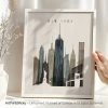 Framed artwork depicting the New York City skyline with notable buildings and the Statue of Liberty.
