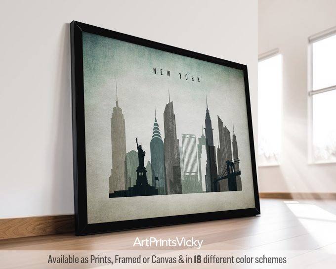 Framed artwork depicting the New York City skyline with notable buildings and the Statue of Liberty.