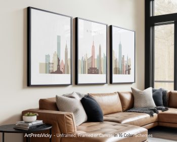 Three framed art prints of the New York City skyline featuring iconic buildings.
