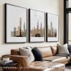 Three framed art prints depicting the New York City skyline with various buildings and structures.