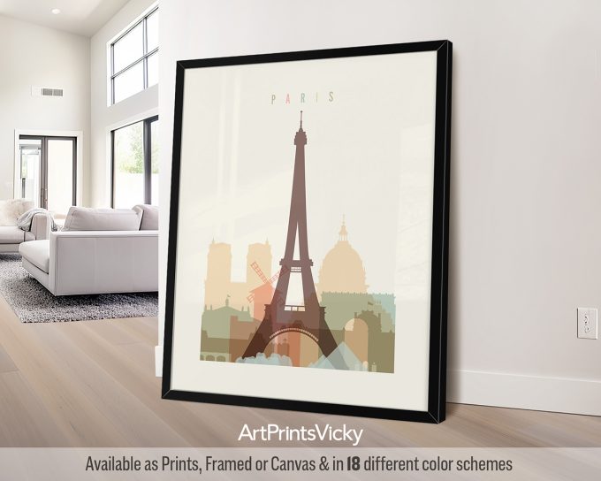 Framed artwork featuring a silhouette of the Eiffel Tower and other Paris landmarks in soft colors.