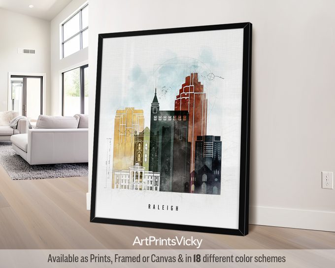 Framed artwork depicting a cityscape of Raleigh with various building silhouettes in different colors.