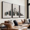 Three framed art prints depicting a Seattle cityscape with the Space Needle and skyline.