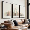 Three framed art prints depicting a stylized cityscape of Seattle with notable landmarks.
