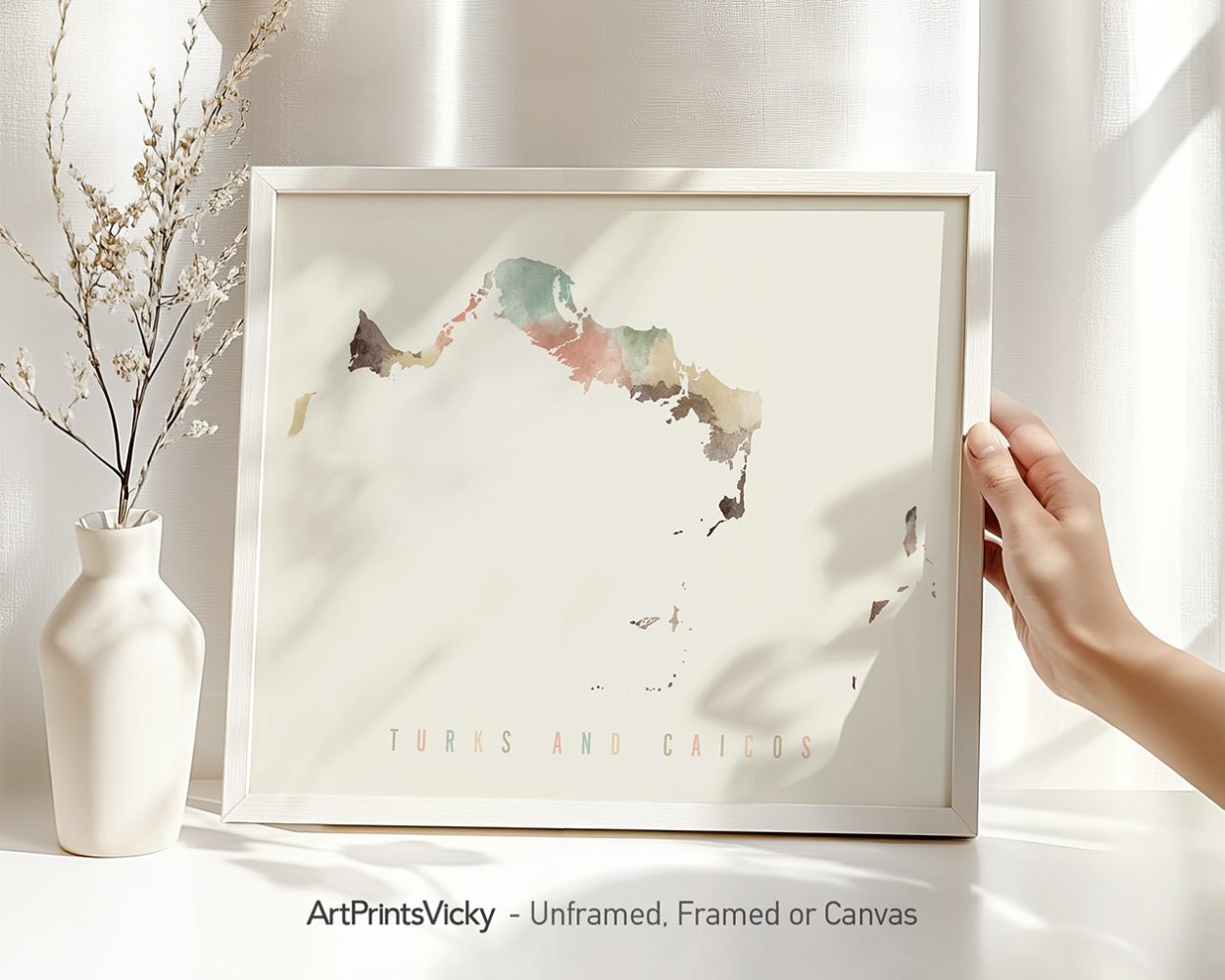 Artistic map of Turks and Caicos displayed in a frame with a hand holding it.