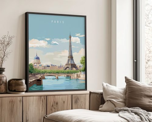 Framed artwork of the Eiffel Tower with a blue sky and clouds in the background.