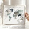 Artistic representation of a world map in muted colors with the phrase 'Adventure Awaits' at the top.