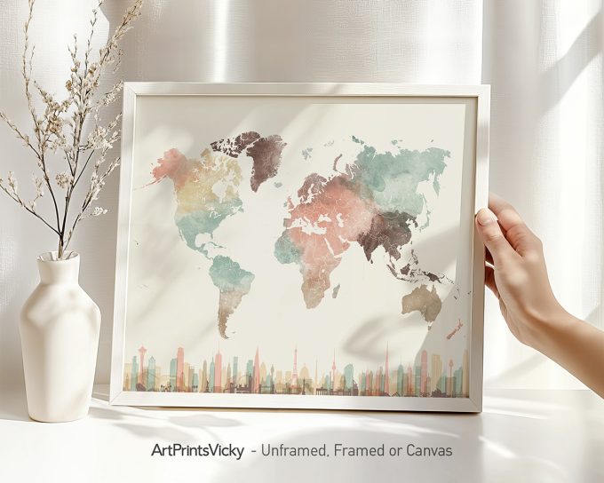 A watercolor world map featuring various colors representing different regions, held in a hand with a vase in the background.