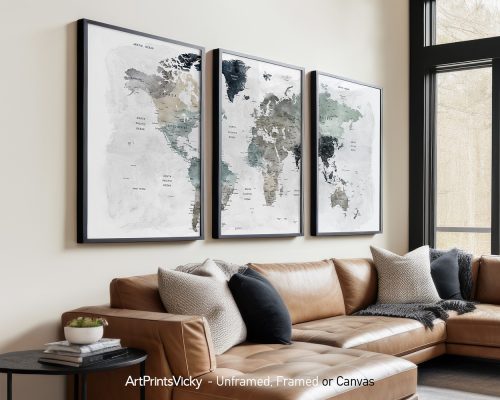 Three framed maps of the world displayed on a wall above a sofa in a living room.