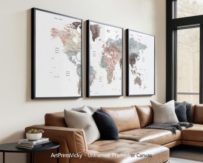 Three framed world maps displayed on a wall above a couch in a living room setting.